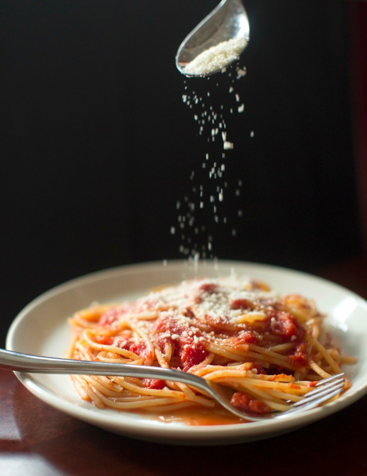 BRUNSWICK, ME - APRIL 3: Christine Burns Rudalevige sprinkles cheese on a plate of pasta with Marcella HazanÕs tomato butter sauce, flavored with kelp on Wednesday, April 3, 2019. (Staff photo by Brianna Soukup/Staff Photographer)