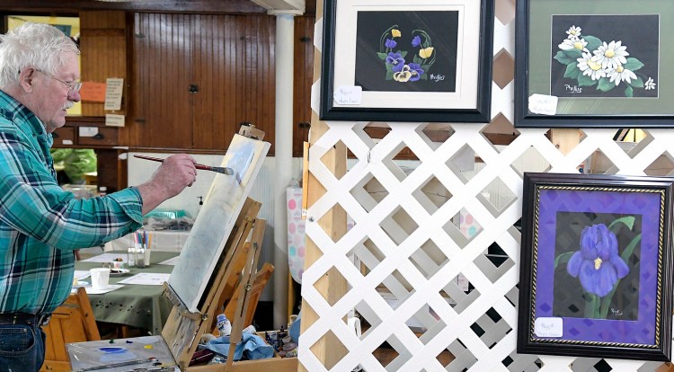 Jim Pecker paints with acrylics Sunday during an art show at the grange hall in Richmond.
