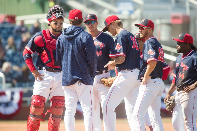 Pitching coach Paul Abbott and the Portland Sea Dogs’ infielder joins pitcher Tanner Houck, 20, on the mound during a three-run fourth inning Saturday that helped the Reading Fightin Phils to an 8-1 victory at Hadlock Field.