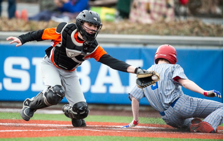 Messalonskee's Evan DeMott (9) slides home before the ball gets to Gardiner catcher Kyle Adams (21) during a preseason scrimmage at Colby College.