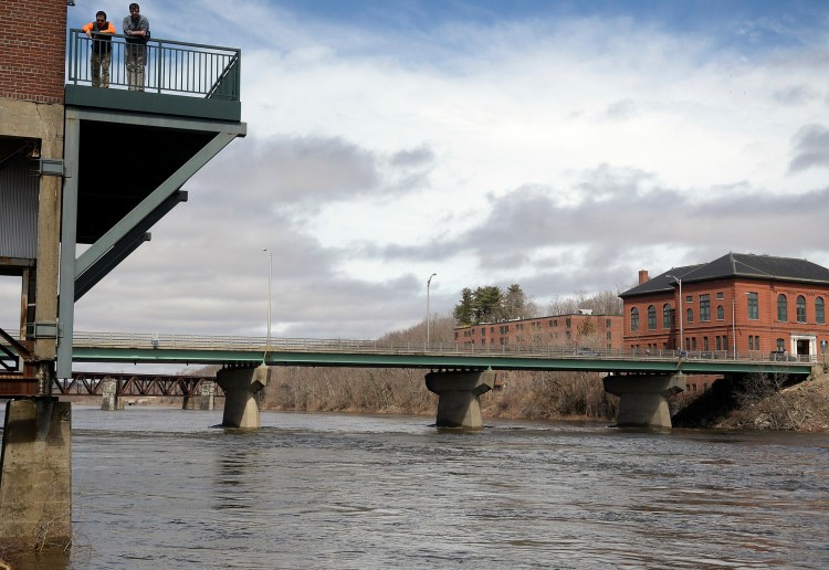 SGC Engineer employees survey the Kennebec River on Monday from their office building deck in Augusta.