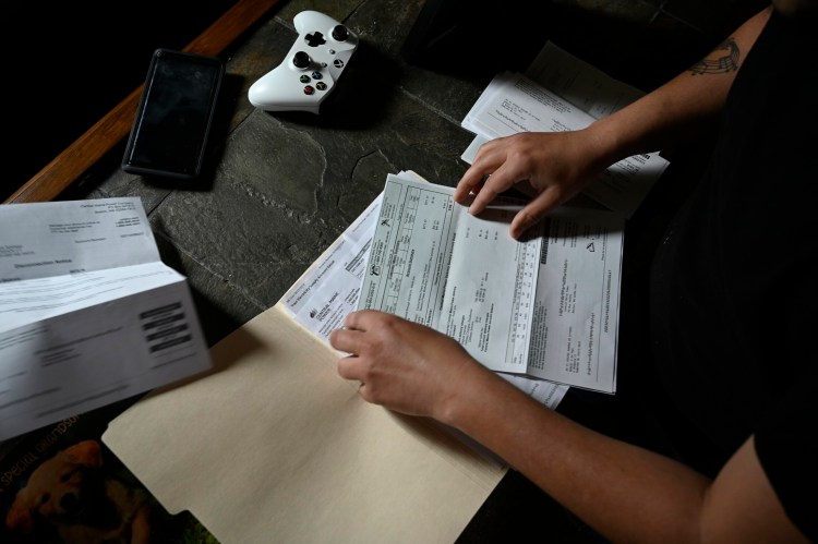 SANFORD, ME - APRIL 19: Rob DuPaul of Sanford looks through his CMP bills Friday, April 19, 2019. (Staff photo by Shawn Patrick Ouellette/Staff Photographer)