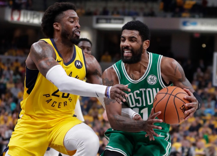  Celtics guard Kyrie Irving, right, is fouled by Pacers guard Wesley Matthews, left, during Game 4 of their Eastern Conference first-round playoff series on Sunday in Indianapolis. The Celtics won 110-106 to win the series 4-0.