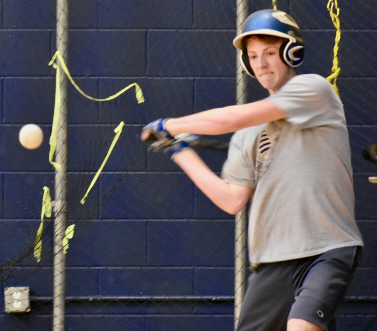 A Mt. Blue player takes a swipe at the baseball in the batting cages. (Franklin Journal photo by Tony Blasi)