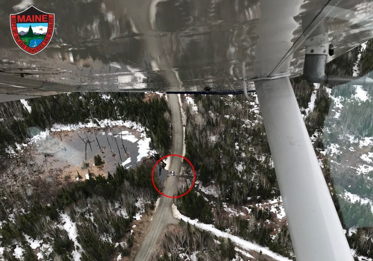 An aerial photo from the Maine Warden Service shows a car found stranded on a remote logging road in Piscataquis County. 