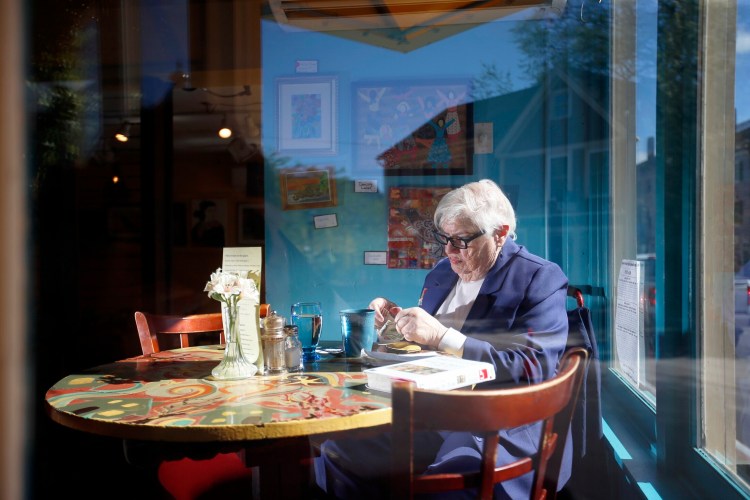 Rena Heath, 82, counts money to leave a tip after having coffee and a small breakfast at Slate's restaurant in Hallowell. 