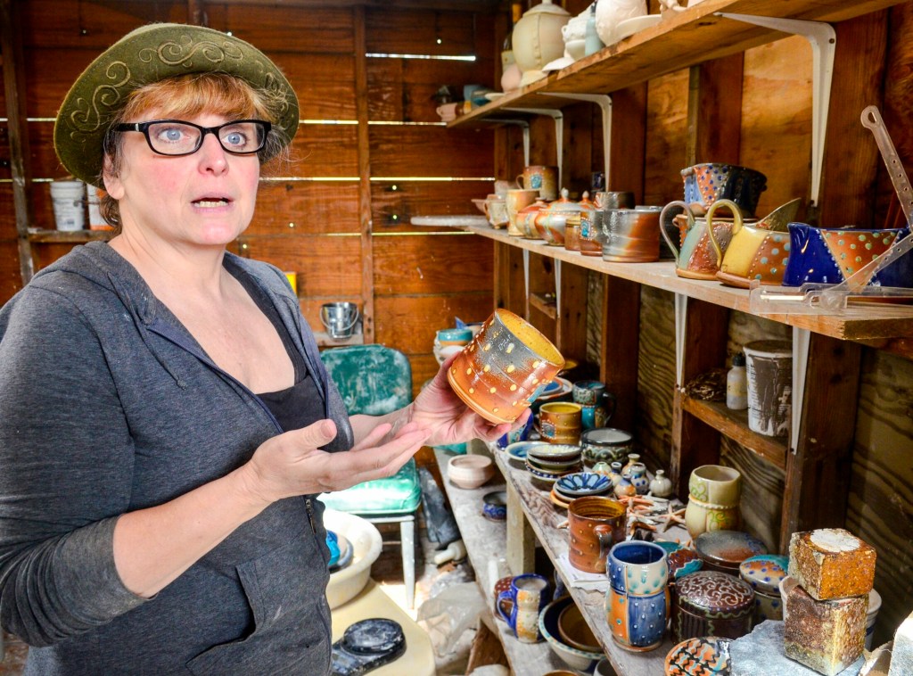 Lori Watts talks about pieces she took out of the kiln earlier in the morning Saturday during a Maine Pottery Tour event at Fine Mess Pottery in Augusta.