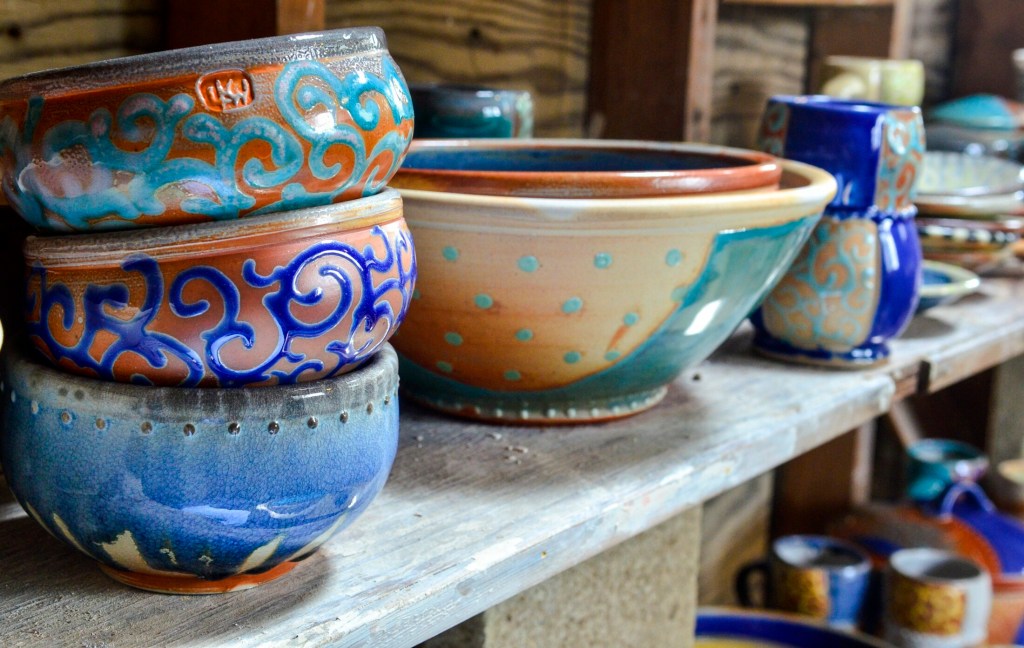 Some of Lori Watts' bowls sit on a shelf in her studio Saturday during a Maine Pottery Tour event at Fine Mess Pottery in Augusta. 