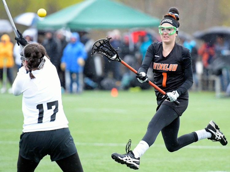 Winslow's Taylor Rodriquez fires past the Hawks' Hailey Grenier on Tuesday at Kents Hill. 