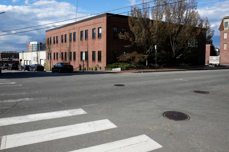 Plans for a women's healing center at 55 Portland St., formerly a city-owned building, are up in the air because zoning and contract restrictions. 