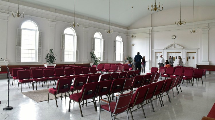 Amarinda Keys, executive director of the Children's Discovery Museum, facing group, leads a tour on May 22, 2019, of the new museum that will occupy the sanctuary at the First Congregational United Church of Christ in Waterville.