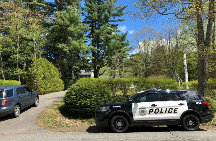 Vehicles from the Augusta Police Department and the state fire marshals office stand parked outside a home at 230 Ward Road in Augusta while personnel investigate the cause of an early morning fire Tuesday that damaged the home.