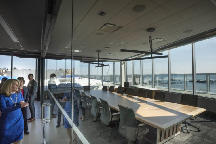 Melissa Smith, CEO and president of Wex, shows people a conference room during a tour of the company's new headquarters in March. On Thursday, the company reported strong first quarter revenue.