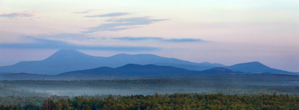 PATTEN, ME - July 15: Early morning haze colors Mount Katahdin and its surrounding mountains on Tuesday, July 15, 2014, seen from a height of land along Route 11 in Patten. The viewpoint is part of the Katahdin Woods & Waters scenic byway. (Photo by Gregory Rec/Staff Photographer)