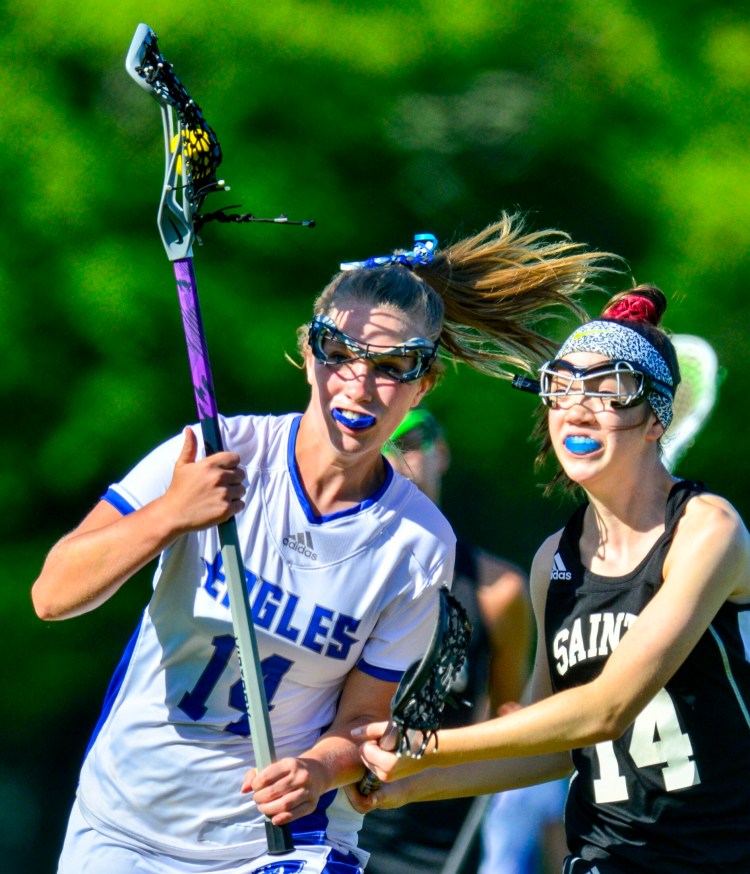 Erskine's Kassidy Wade, left, tries to get around St. Dominic's  Raegan Hachey during a Class C semifinal game Wednesday in South China. 