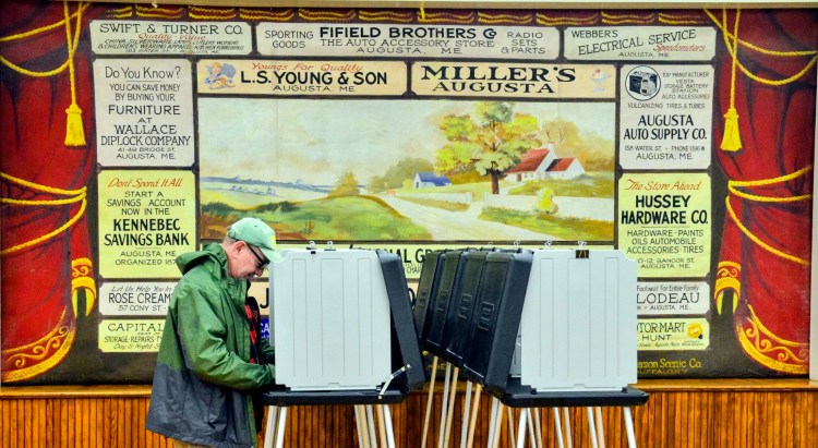 A voter marks a ballot on Tuesday at the town's polling place on the second floor of Windsor Town Hall. The Windsor ballot included items asking residents about selling alcoholic beverages in restaurants. 