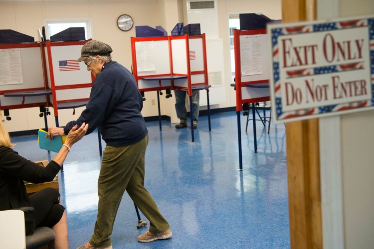 Joyce Goodine casts her ballot Tuesday at the China Town Office. Voters rejected a proposal to take a second step toward establishing a consolidated emergency services building that would place the China Village Fire Department, the Police Department and the Rescue Department under one roof.