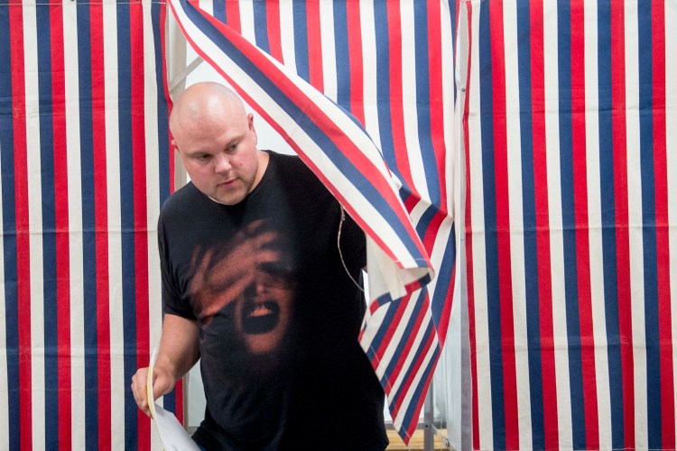 Andrew Staples emerges from the voting booth with his ballots at the Skowhegan Municipal Building in Skowhegan on Tuesday. Candidates for municipal and school offices along with the SAD 54 school budget were on the ballot.