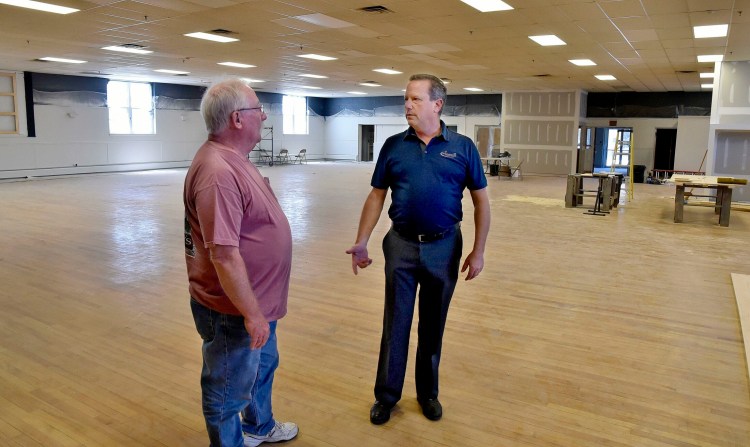 Bill Mitchell, owner of the former American Legion building in Waterville, speaks with property manager Jay Conway on June 24. Mitchell plans to renovate the large space on College Avenue into an events center called The Elm.  