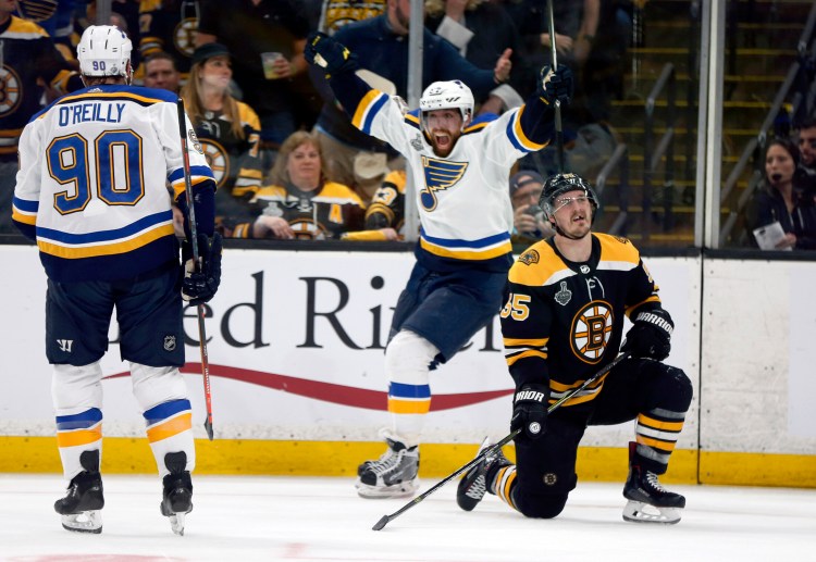 David Perron of the Blues celebrates his third-period goal behind Boston's Noel Acciari on Thursday night in Boston. Acciari was taken down by Tyler Bozak earlier on the play, but no penalty was called.