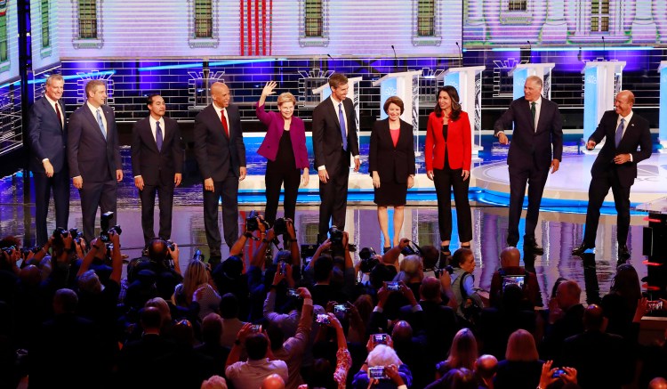 From left, New York City Mayor Bill de Blasio, Rep. Tim Ryan, D-Ohio, former Housing and Urban Development Secretary Julian Castro, Sen. Cory Booker, D-N.J., Sen. Elizabeth Warren, D-Mass., former Texas Rep. Beto O’Rourke, Sen. Amy Klobuchar, D-Minn., Rep. Tulsi Gabbard, D-Hawaii, Washington Gov. Jay Inslee, and former Maryland Rep. John Delaney pose for a photo on stage before the start of Wednesday's Democratic primary debate hosted by NBC in Miami.