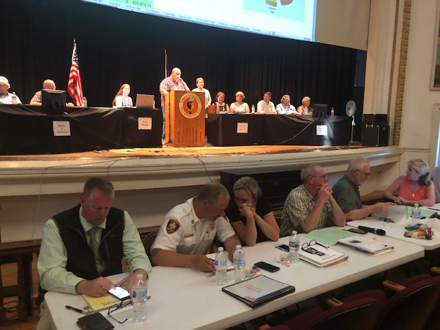 Skowhegan municipal department heads, front, and members of the Board of Selectmen and Budget and Finance Committee get ready for voting Monday night at Town Meeting.