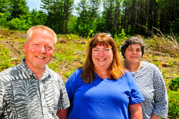 From left, Uplift Inc.'s Leroy Usher, director of maintenance; Jennifer Kinnelly, director of support services; and Ame Drake, director of program services. The trio were at the site of the nonprofit's planned five-unit building on Lewis Avenue in Randolph on June 28.