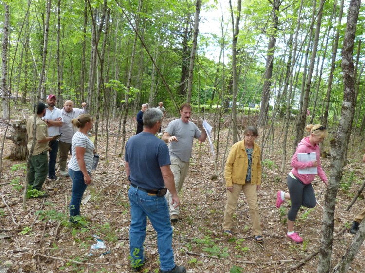 Richmond Planning Board members and abutters of a proposed 14-lot subdivision off U.S. Route 201 near Stillwater Lane walk through the property with land surveyor Jan Boucher, center, Tuesday evening.