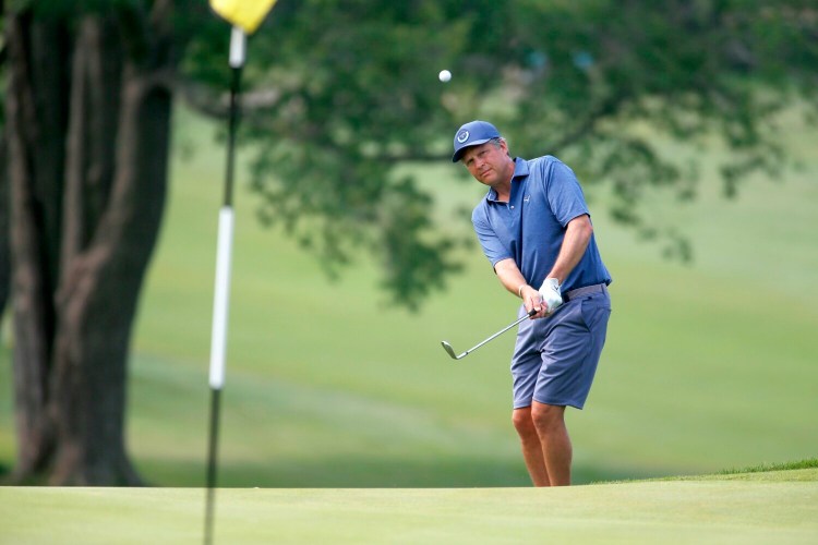 Jason Gall chips onto the ninth hole. Gall had a hole-in-one on the fourth hole and finished the day with 68 and a total of 140 over after two rounds.