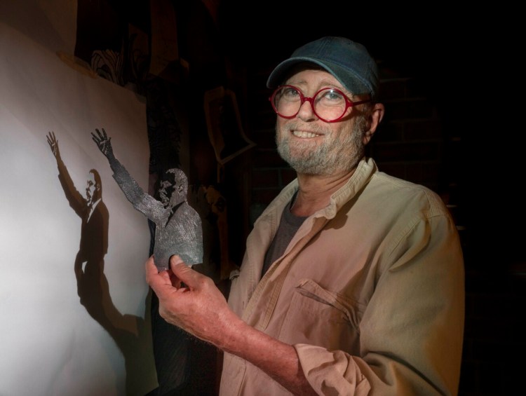 Artist and architect Roger Richmond holds a metal cutout depicting Dr. Martin Luther King Jr. in his South Freeport studio on Thursday.
