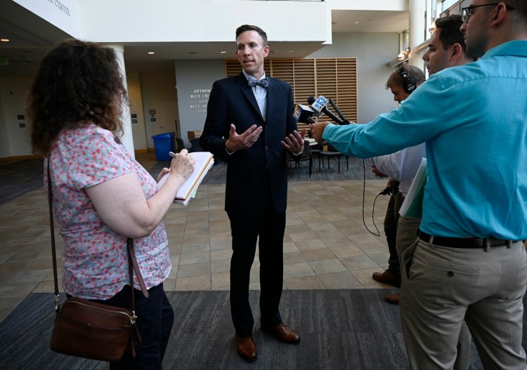 Phil Bartlett, the new chairman of the Maine Public Utilities Commission, speaks during a news conference Tuesday at the University of Southern Maine, where the PUC began a series of hearings on Central Maine Power's customer service and billing problems, and its request for a rate hike.
