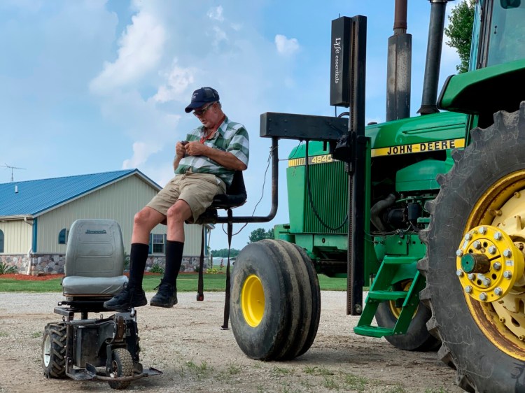 Farmer Mark Hosier, 58, uses a lift to get into a tractor on his farm in Alexandria, Ind., earlier this month. Hosier was injured in 2006, when a 2000-pound bale of hay fell on him while he was working. Assistive technology, help from seasonal hires and family members, and a general improvement in the health of U.S. seniors in recent decades have helped farmers remain productive and stay on the job well into their 60s, 70s and beyond.