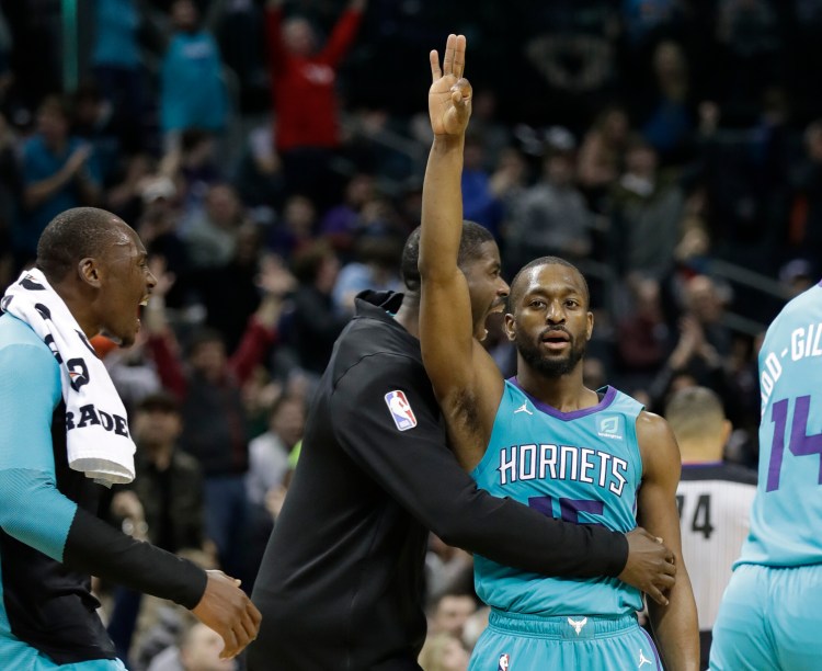 Kemba Walker, center, will join the Boston Celtics to replace Kyrie Irving. Walker, who won an NCAA title with UConn, is a three-time All-Star.