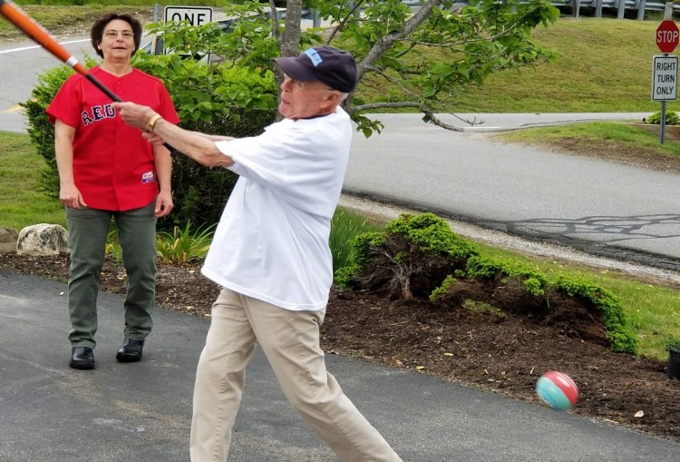 Julie Adams, chef at Lincoln Home in Newcastle, cheers on Phil Cameron, 90, during the 14th annual baseball game.