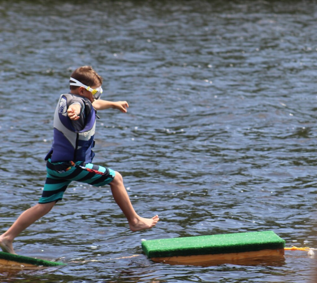 Baylor Hutchings, 6, takes a leap of faith onto a lobster trap during Richmond Days on Saturday.