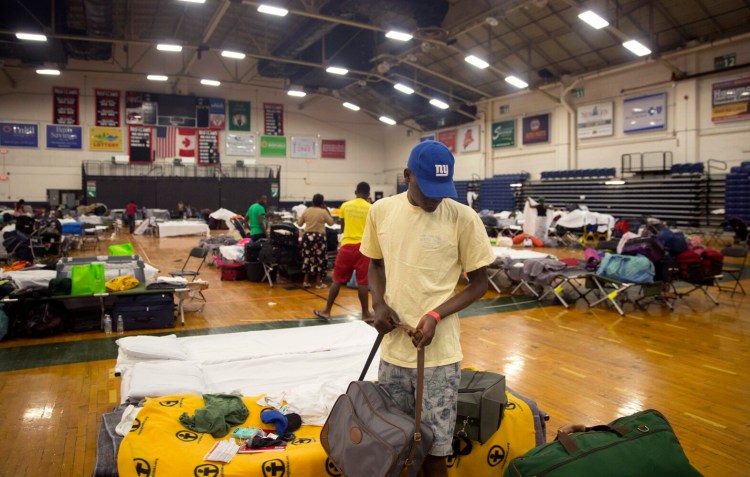 An asylum seeker who asked not to be named packs up this family's belongings on Wednesday. He and his family are being moved to Portland's family shelter.