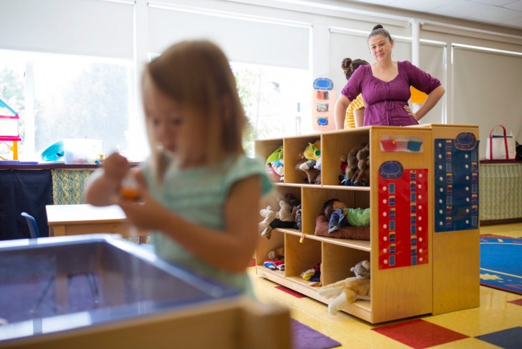 Stacey Menard watches as her new pre-kindergarten student Holly Hibbard, 3, plays in the sandbox during a drop-in day before the start of school this week at Dunn Elementary School in New Gloucester. Gov. Janet Mills has made expansion of pre-kindergarten a priority.