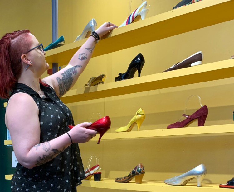 Emma Sieh, collections and exhibits coordinator at Museum L-A, looks over shoes that are part of its current footwear exhibit. Some of the shoes will be used in its upcoming “The Shoe Must Go On” shoe fashion show being held Friday, Sept. 20, at the Lewiston museum. Community members willing to model shoes in the shoe fashion show, as well as lend their own shoes, are being sought. Deadline for submission forms is Aug. 20.