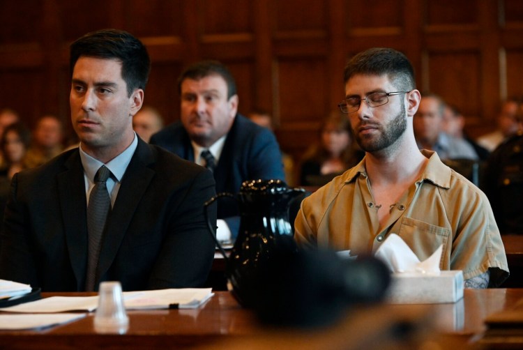 John D. Williams closes his eyes as Justice Robert Mullen hands down the maximum sentence for the murder of Cpl. Eugene Cole. Defense attorney Patrick Nickerson sits next to Williams at the sentencing on Sept. 12, 2019.