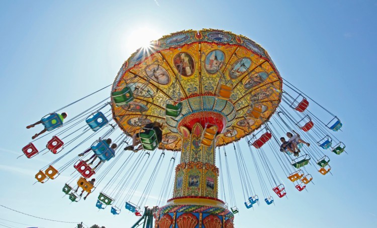 Riders fly through the air on the swings Sunday at the Cumberland County Fair in Cumberland. 