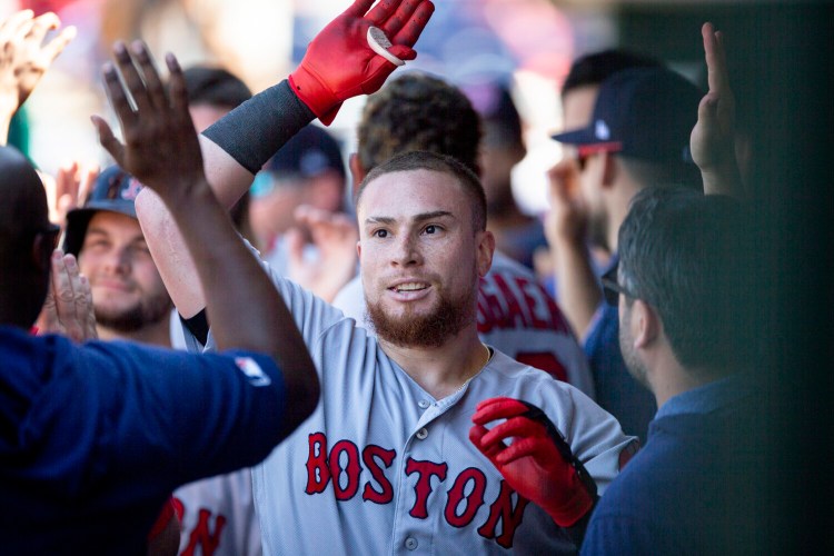 Red Sox catcher Christian Vazquez celebrates with his teammates in the dugout after hitting a grand slam in the third inning of Boston's 6-3 win over the Phillies on Sunday in Philadelphia.