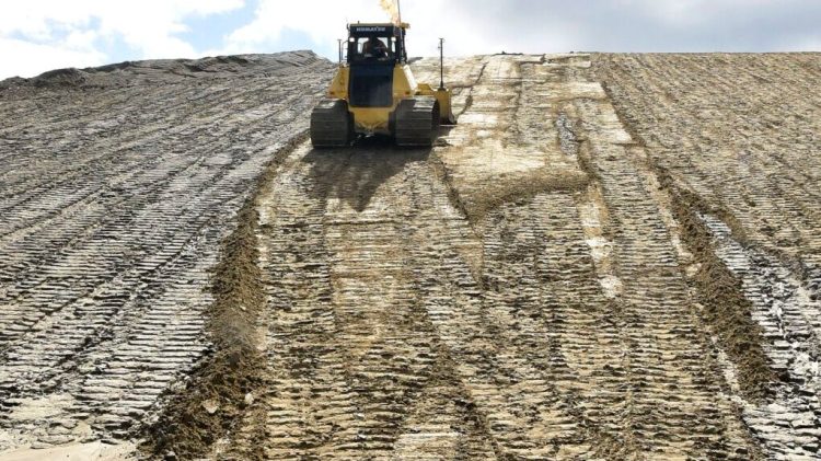 A bulldozer is used in August 2018 to cap a section of the Crossroads Landfill, operated by Waste Management Disposal Services of Maine.