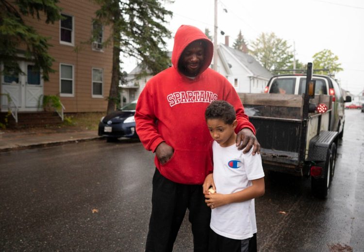 Javon Jarrett stands with his father, Neil, in Sanford on Monday. Neil Jarrett and Javon's mother, Jessica Gouin, say they are disappointed and upset that an assistant principal used a racial slur to make a point about hurtful language while taking with Javon, a fourth-grader at Williard School in Sanford.