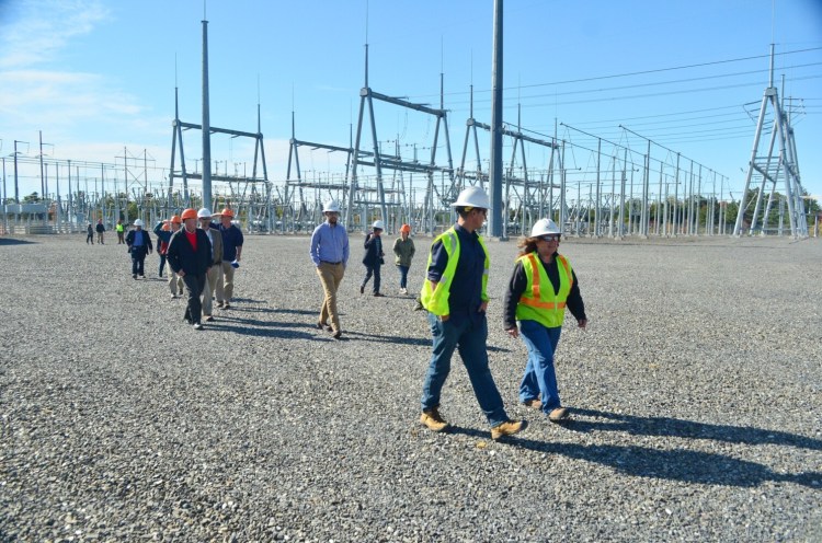 Debra Simmons, CMP class 1 substation worker far right, leads a tour Wednesday at Central Maine Power Co.'s Coopers Mills substation in Windsor. Federal rules prohibited taking photos inside the STATCOM building.