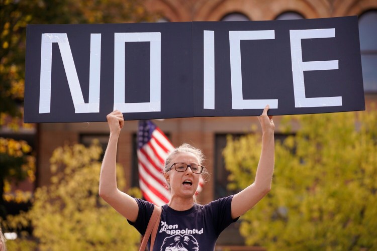 Emily Qualey of Portland holds a “No ICE” sign while chanting at a protest on Monday against an Immigration and Customs Enforcement office that will soon open at One City Center in Portland. 