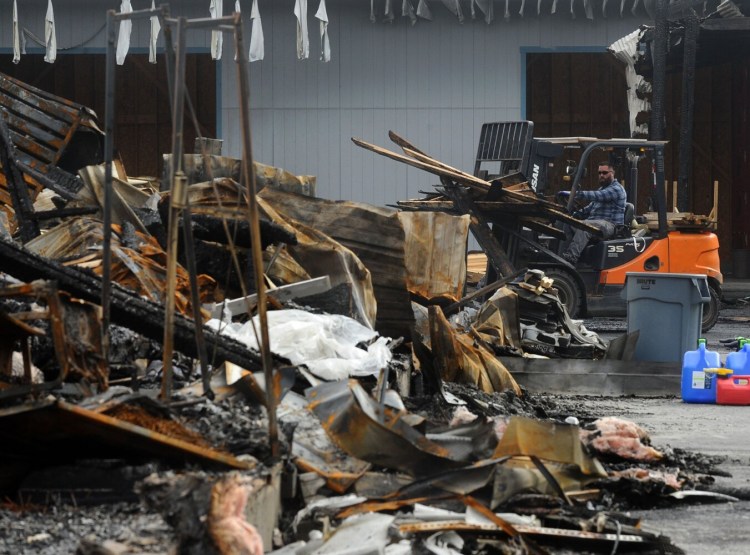 Cleanup was underway at McCormack Building Supply in Winslow shortly after fire inflicted heavy losses on the business on Oct. 13.