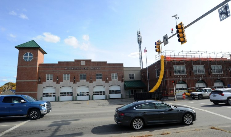Traffic passes the historic Waterville firehouse, right, and the current firehouse in Waterville Wednesday. If an ambulance service is created, it will be housed in the old fire station, where work is being done.