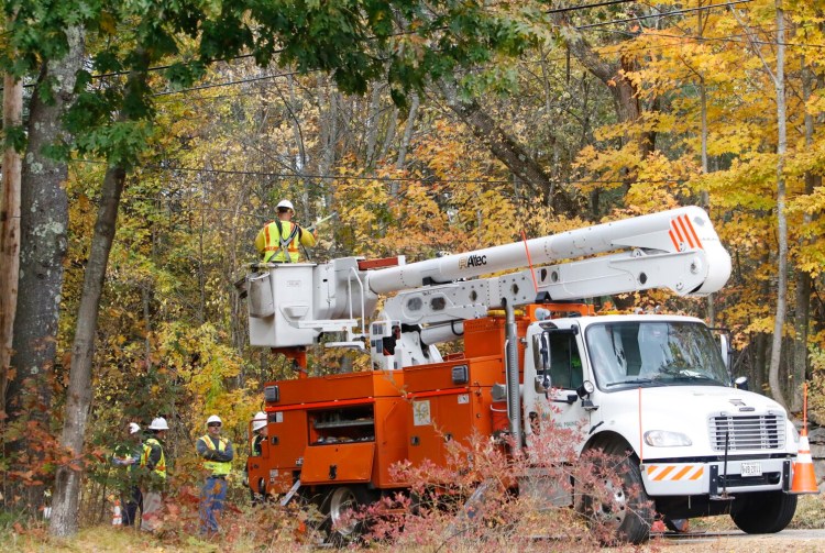 Central Maine Power crews work to restore electricity along School Street in Alfred on Friday in the wake of a nor'easter last week.
