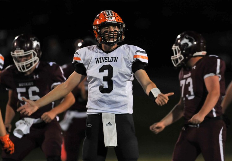 Winslow quarterback Colby Pomeroy looks toward the sideline for assistance during the game against MCI on Friday night in Pittsfield.