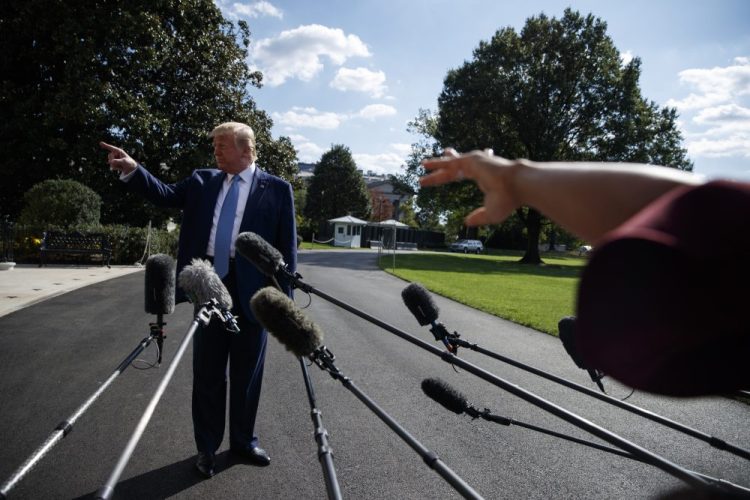 President Trump talks to reporters on the South Lawn of the White House on Friday.